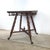 A commanding showcase of historic woodwork, this antique accent table serves as a dramatic structural anchor for any...
