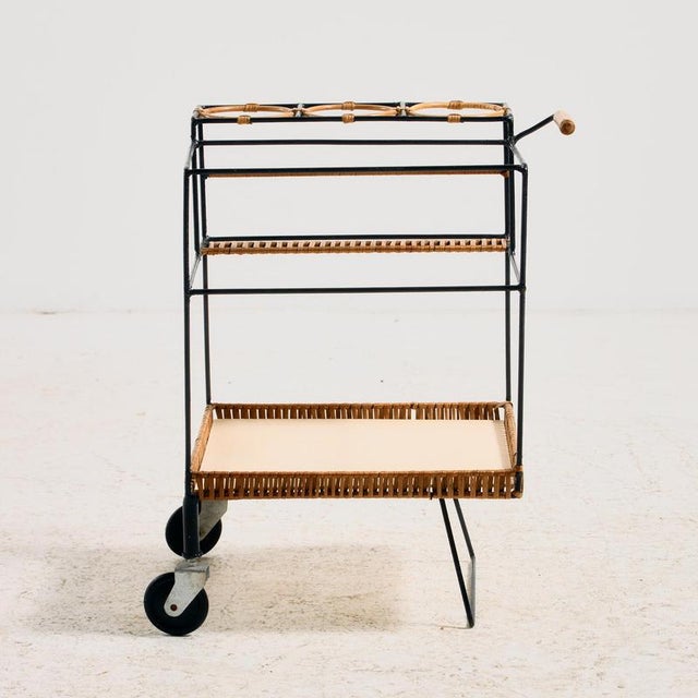 A metal serving cart with bamboo and wicker details from the 1960s. A truly multifunctional piece that offers a stylish...
