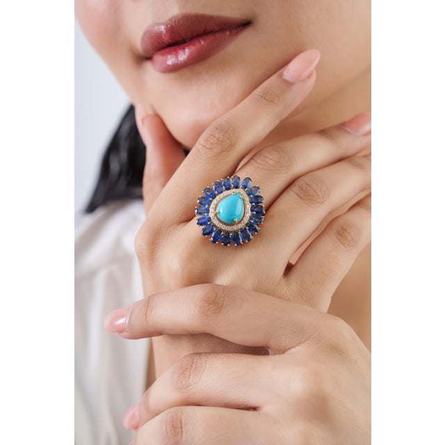 This statement ring showcases an 8.41-carat turquoise & blue sapphire set in 14k yellow gold. The turquoise measures...