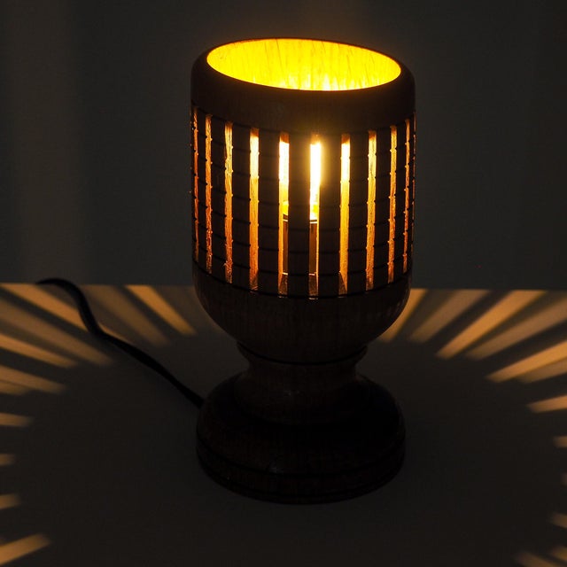 Bring warm, ambient character to your space with this solid wood accent lamp. Expertly turned and carved with a geometric...