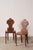 Pair of 19th-century oak hall chairs with carved backs, solid plank seats, and turned front stretchers. Constructed of oak...