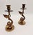 Elevate your space with this striking pair of vintage patinated brass candlestick holders, sculpted in an elegant dolphin...