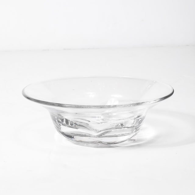 An elegant Mid-Century Modernist crystal bowl, featuring organic base detailing, signed Orrefors, originates from Sweden,...