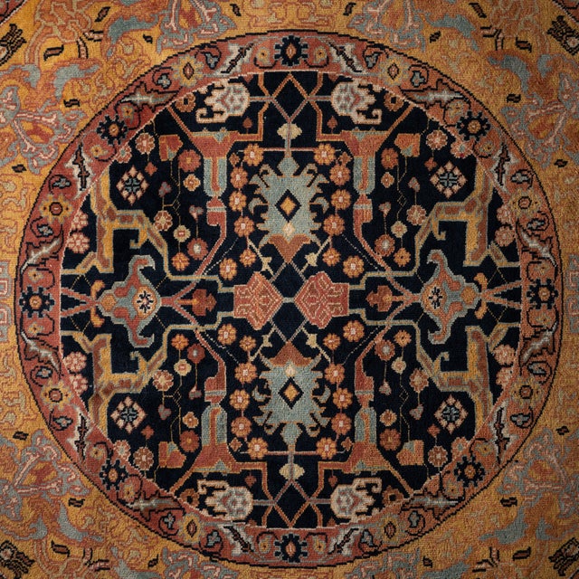 A round Indo-Persian rug, circa 1960. The 72‑inch hand-knotted wool pile rug centers a black medallion with geometric...