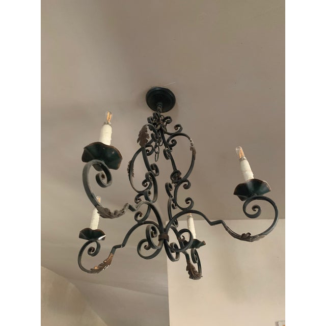 Elegant four-arm French Provincial chandelier crafted from hand-forged wrought iron. Features gracefully curved arms,...