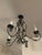 Elegant four-arm French Provincial chandelier crafted from hand-forged wrought iron. Features gracefully curved arms,...