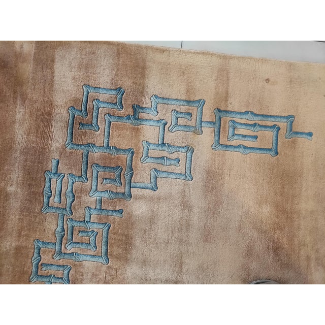 A border-less soft gold ground of this Tianjin 1930s carpet has a blue fretwork in the upper right corner and a facing...