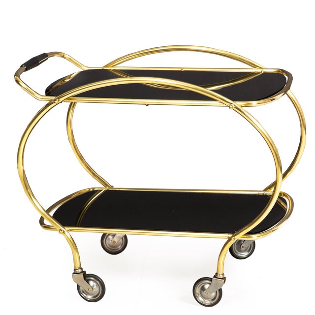MID-CENTURY BRASS AND BLACK GLASS TWO-TIER SERVING CART Probably United States, circa 1950s Item # 311WGP02K A super fun...