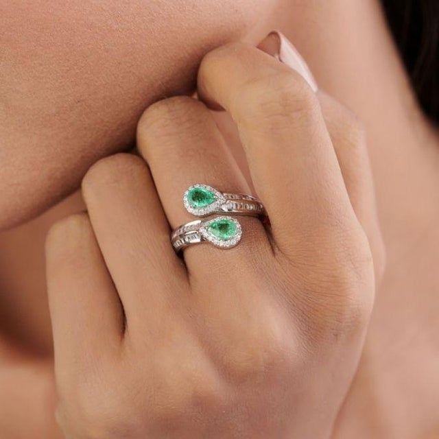 This contemporary bypass ring in featuring 0.72 carats two elegant pear-shaped emeralds, set in 14K white gold. Each stone...