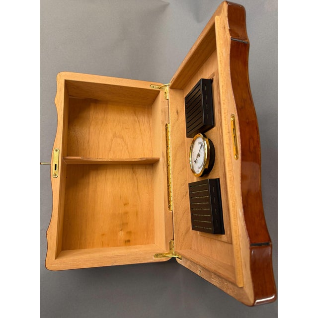 This classic cigar humidor features a Spanish cedar–lined interior and traditional brass hardware, offering both function...