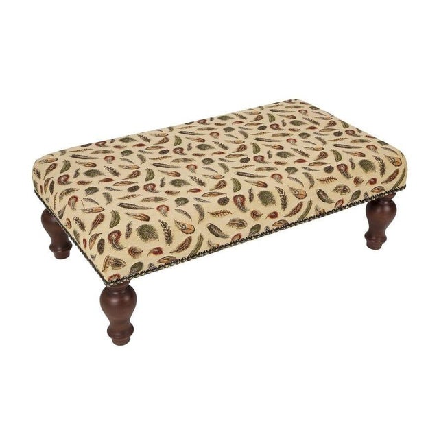 Meticulously handcrafted in the United Kingdom, this upholstered stool boasts classic studding and hand-polished solid...