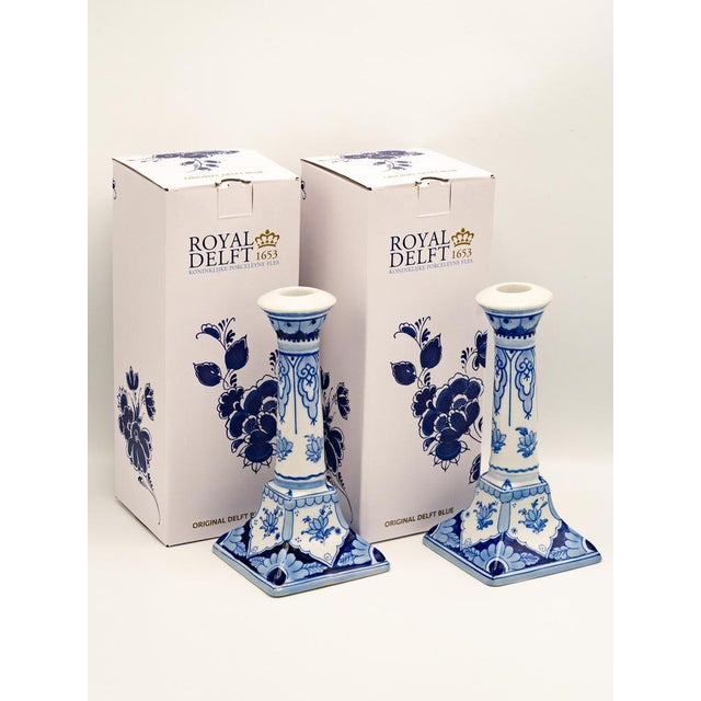 This rare and elegant pair of Royal Delft candlesticks, produced by De Porceleyne Fles in 1988, showcases the mastery of...