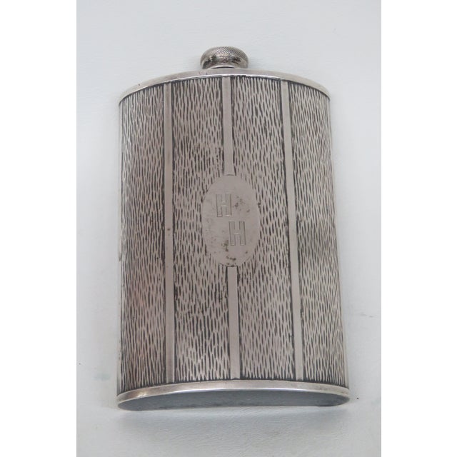 This gorgeous vintage hip flask features a beautiful "HH" monogram, twist on cap attached by a hinge, and was made by...