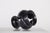 A black terracotta candle holder, baluster-shaped on a pedestal, decorated with openwork, made in Vallauris around 1975....