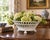 An elegant early 20th-century French porcelain cachepot with a flared oval form, crisp white glaze, and beautifully...