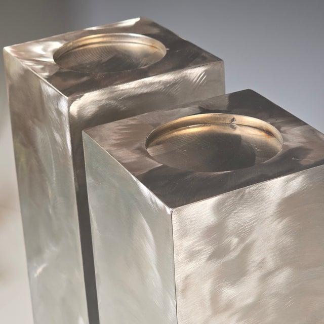 These two candleholders are made from welded heavy gauge stainless steel and are finished in a free form abstract swirl...