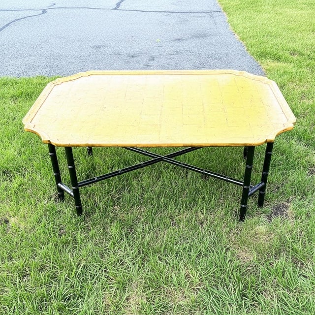 This gorgeous Kittinger coffee table features a scalloped edge top with a gilded block finish. It is attached to it legs...
