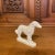 A beautiful Staffordshire pottery style figure of a borzoi or Russian Wolfhound. White with gold gilt accents.