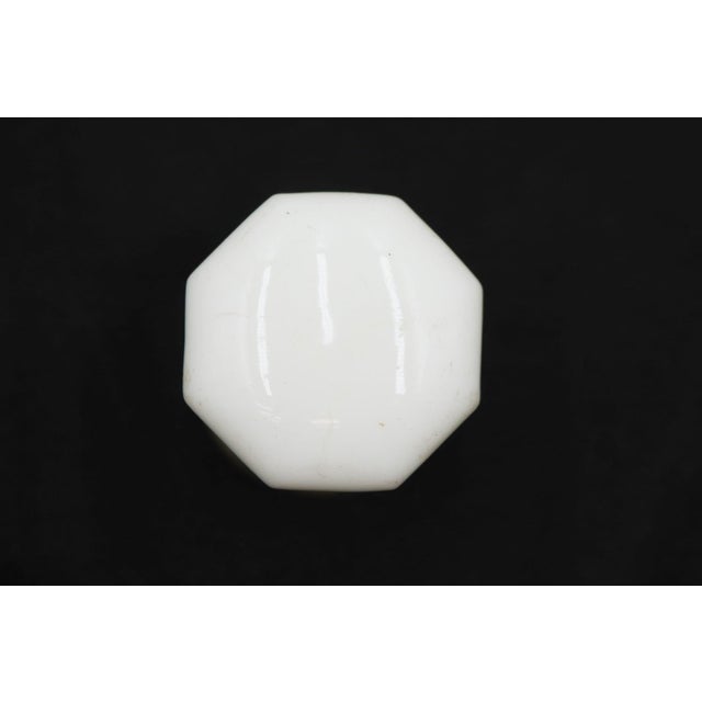 Antique plain milk glass door knob paired with a nickel plated brass rosette. The original rosette mounting screws are not...