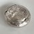 Elegant antique Art Nouveau pill box crafted in solid silver (800), featuring a finely repoussé floral design with...