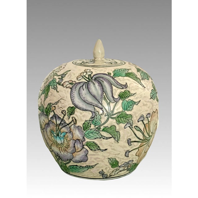 Nicely shaped & richly enamel ovoid ginger jar decorated by hand on the Island of Macau, China with an abundance of exotic...