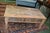 This is a very heavy / substantial wooden coffee table. A shabby / rustic look with numerous colors & a chippy appearance....