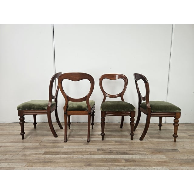 An elegant set of four late-19th-century chairs featuring a refined solid wood frame, beautiful craftsmanship, and a...
