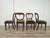 An elegant set of four late-19th-century chairs featuring a refined solid wood frame, beautiful craftsmanship, and a...