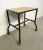 Industrial table from the 1960s. It features an iron construction,a four original wheels and a solid wooden plate. The...