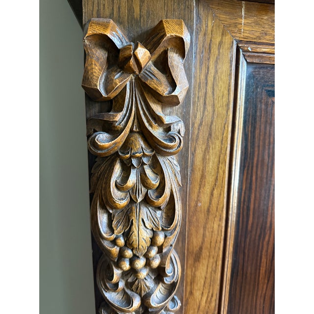 An exceptional monumental carved oak armoire featuring exquisite hand-carved Renaissance Revival ornamentation throughout....