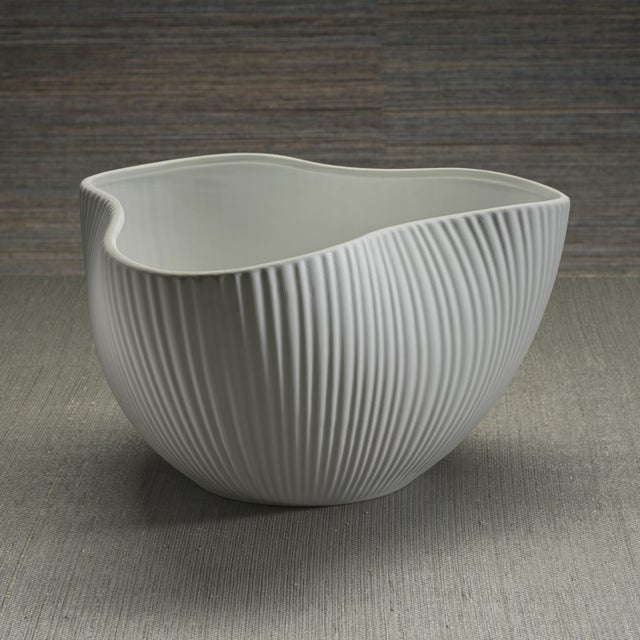 The Organic Ribbed Ceramic Orchid Bowl brings elegance and texture to any tabletop. Its sculptural, asymmetric rim adds a...