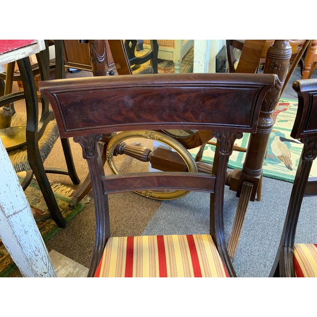 Pair of 19th Century English Regency wood chairs. Carved turned legs, carved detail. Upholstered seats. Legs are a bit...