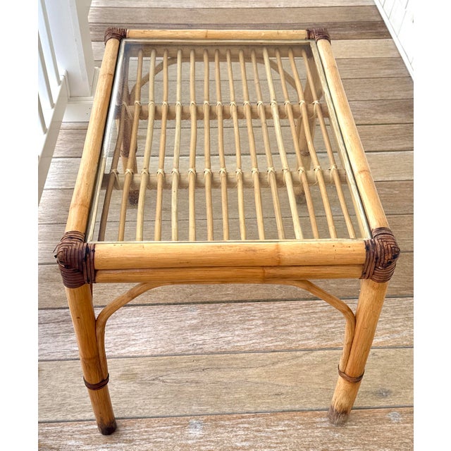 1960s McGuire Style / Ficks Reed style rattan table with glass top. The joints on the rattan frame are wrapped in rawhide,...
