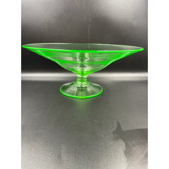 This old Uranium Vaseline Glass centerpiece compote is wonderfully striking and rare. It elevates and accentuates any...