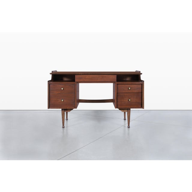 Elevate your workspace with a stunning mid-century modern walnut “Mainline” desk by Hooker Furniture, crafted right here...