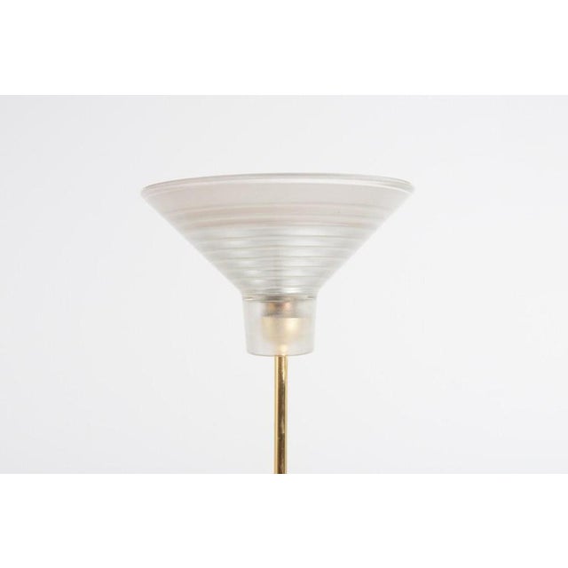 Italian design floor lamps from the 1970s with gold coated steel stand and sculptural glass shade. Condition Good, age...
