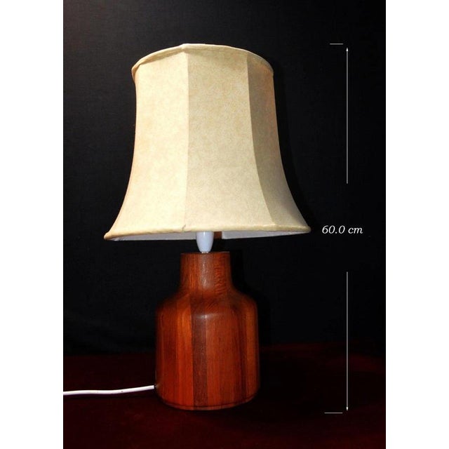 A stylish Danish Mid-Century Modern table lamp dating to circa 1965, combining sculptural Scandinavian teak with a...
