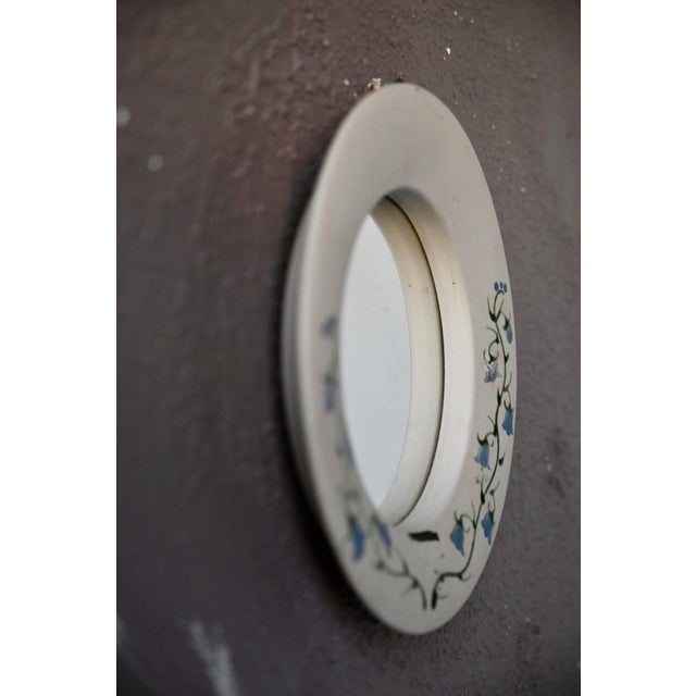 A charming little wall mirror, reminiscent of antique shops and country homes of yesteryear. Its round, matte ceramic...