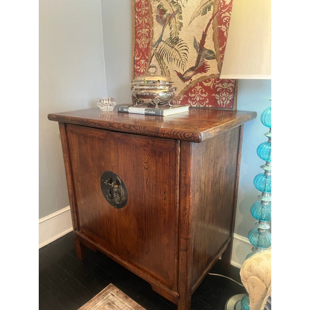 Steeped in quiet elegance, this late Qing Dynasty wedding cabinet was crafted in northern China from solid elmwood, valued...