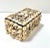 A 1940s handcrafted seashell-encrusted decorative box with layered natural shells and a richly textured coastal surface....
