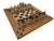 This figural terracotta chess set brings together 32 chess pieces and an oak-framed board. Cream and black accents...