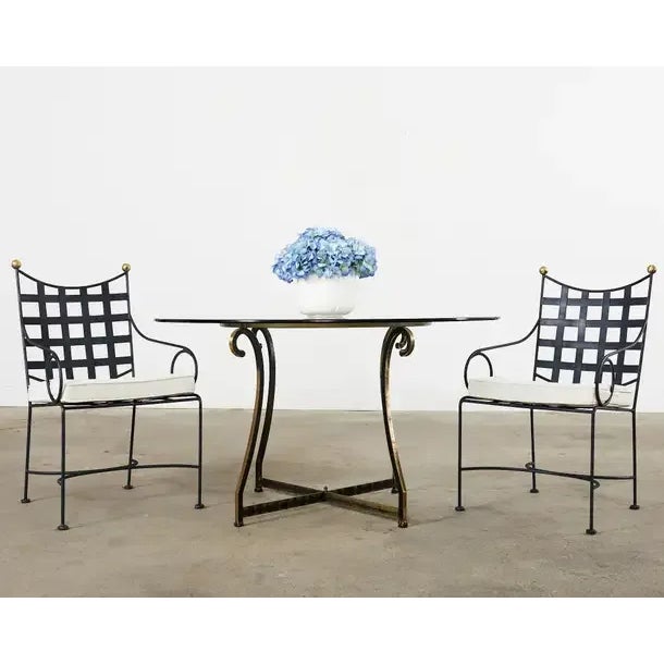 Iconic mid-century modern set of four patio and garden dining armchairs made in the style and manner of Mario Papperzini...