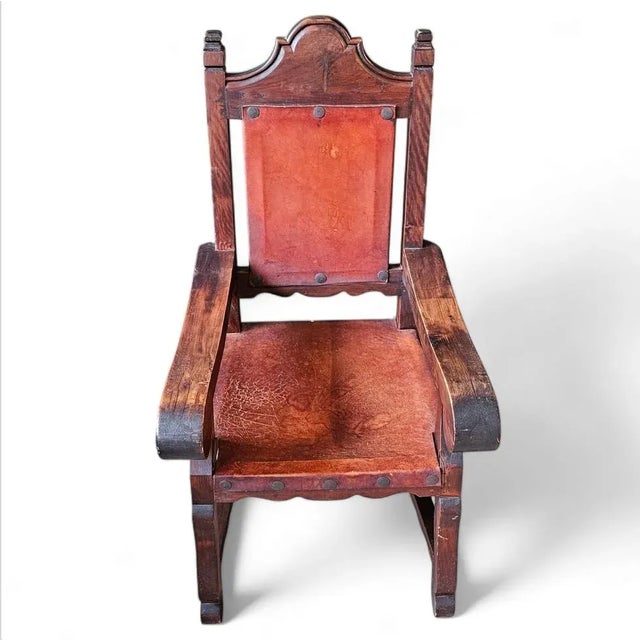 This striking Spanish Colonial-style silla amplia chair captures timeless elegance and craftsmanship. The chair features a...