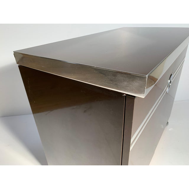 A signed Pierre Cardin bar cabinet on castors. Some vintage wear. The chrome band on one end has some scuff scratches...