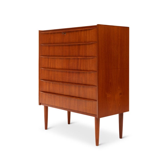 This stunning 1960s Danish Mid-Century teak tallboy dresser is a timeless piece of craftsmanship. Featuring exquisite wood...