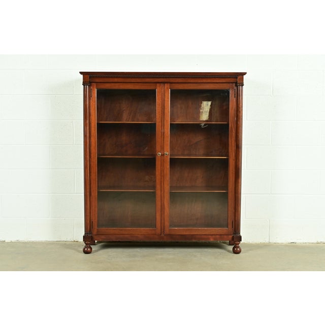 A beautiful antique American Empire or Victorian glass front double bookcase cabinet In the manner of R.J. Horner & Co....