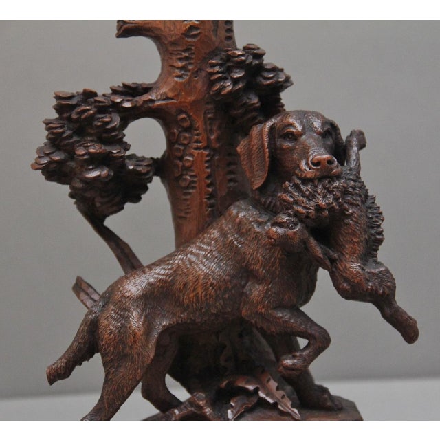 A lovely quality 19th Century black forest centre piece, having an ornate carved trunk at the centre with a removable...