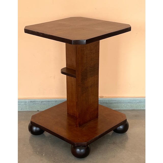 Italian Art Deco octogonal side table, circa 1930s. Narrow ebonized feet and round finial at center base set off the...