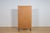 The teak wood bookcase was manufactured in Denmark in the 1960s. The upper section features five open shelves (shelf...