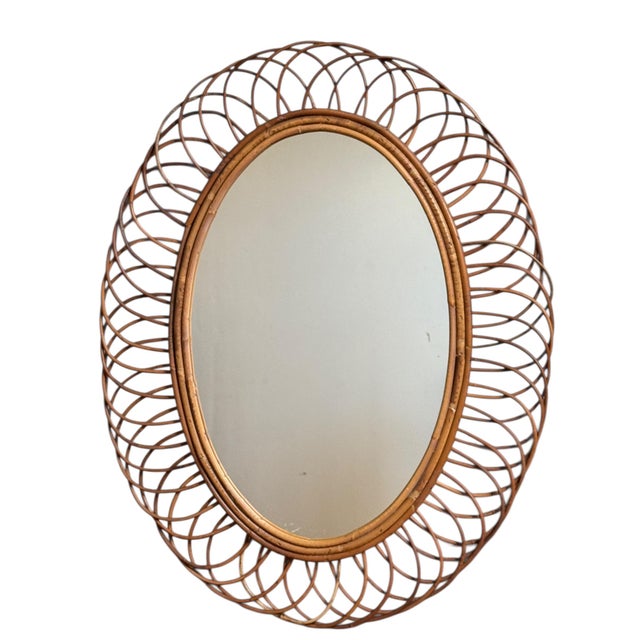 Magnificent rattan sunburst mirror from the 1960s. Handcrafted in the south of France.